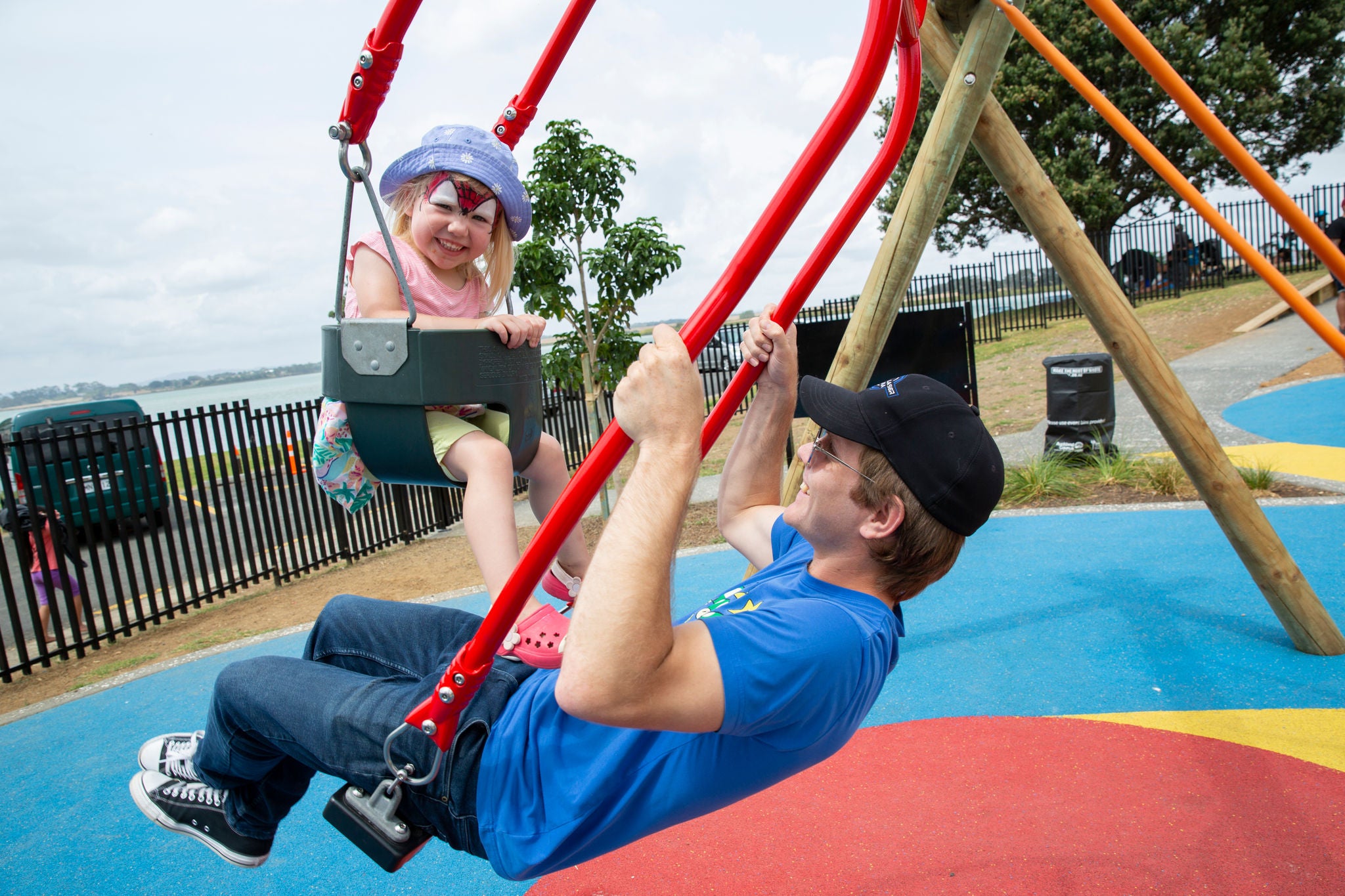 Caregiver and child swings enable social interaction and intergenerational play. 